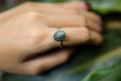 Blue Tourmaline sterling silver ring shown worn on the hand, with a dark blue gemstone and handmade silver setting.