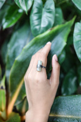Raw Australian Aquamarine ring worn on hand with oxidized sterling silver hammered band.