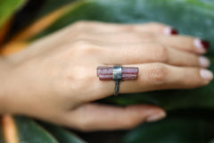 Pink Tourmaline ring worn on a hand, showing soft blush crystal and handmade oxidized silver setting.