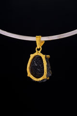 Darwin Glass pendant worn on choker against black background as a Crown Chakra cosmic talisman.