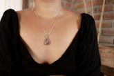 Lightning Ridge Boulder Opal pendant shown worn on a model, with textured sterling silver bezel and freeform Australian opal.