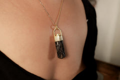 Himalayan Dravite Diamond pendant shown worn on a necklace, with 18k gold-plated sterling silver and dark earthy crystal body.