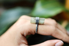 Torrington Aquamarine Forest Ring worn close-up showing raw blue-green crystal and oxidized silver wrap.