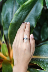 Handmade oxidized 925 sterling silver Himalayan Aquamarine ring shown worn on the hand, with raw blue crystal and hammered band.