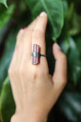 Pink Tourmaline oxidized sterling silver ring worn on a hand with raw blush crystal and hammered band.
