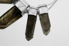 Close-up of Australian Smoky Citrine Phantom Quartz necklace showing five smoky-golden crystal drops and sterling silver details.
