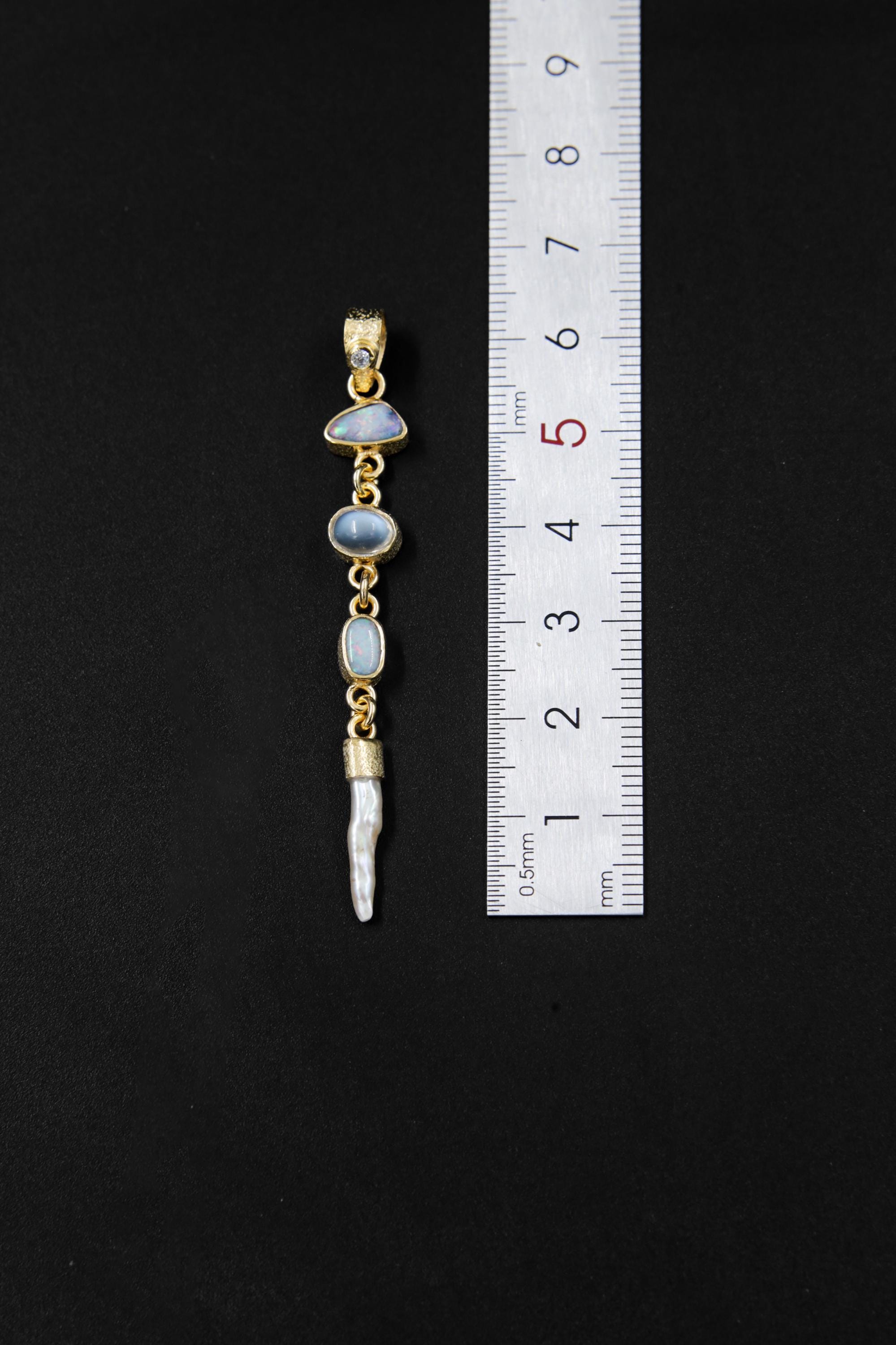 Zircon Australian Opal Blue Moonstone Herkimer Diamond and South Sea Pearl pendant shown beside a ruler for scale, measuring approximately 6.5 cm long.
