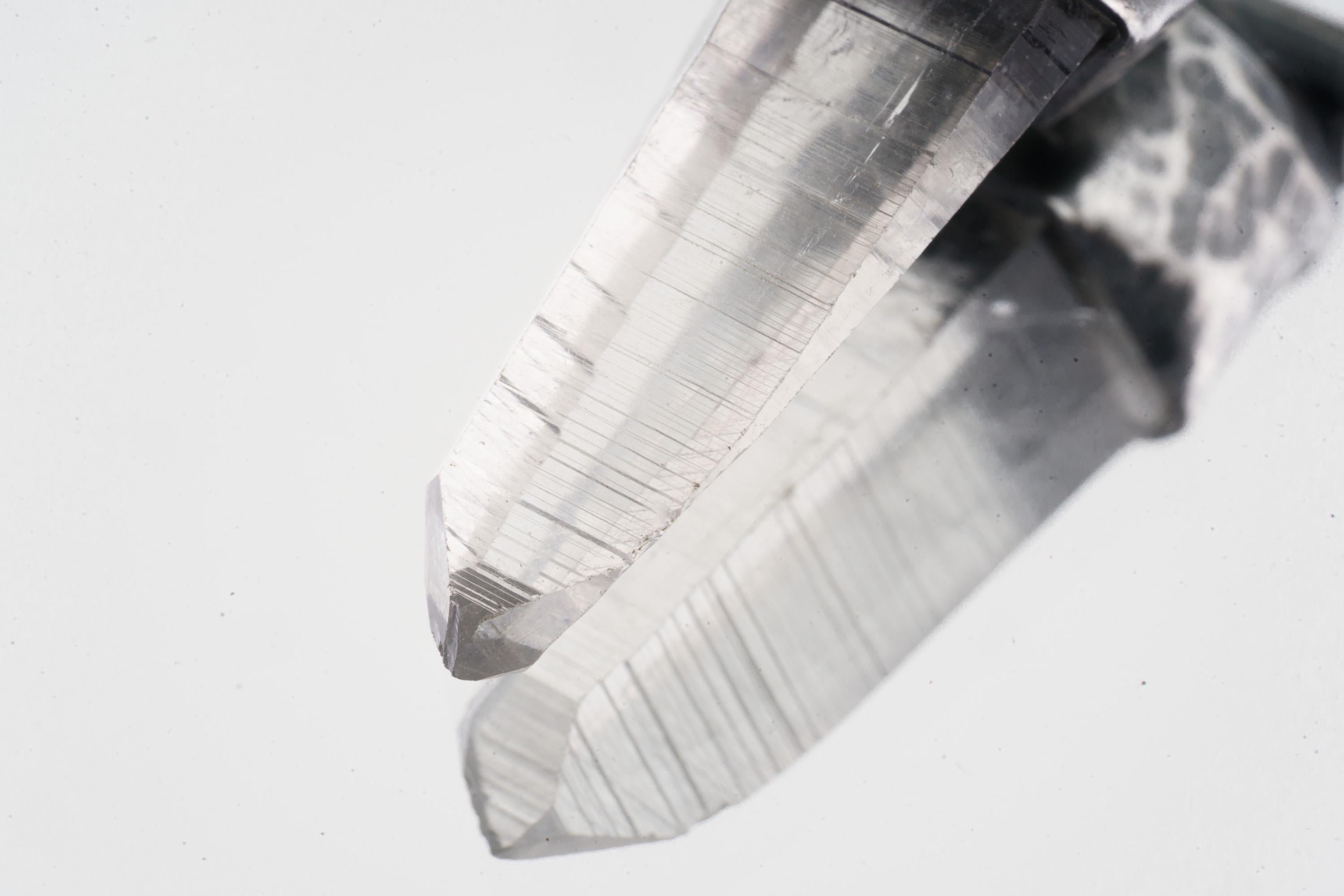 Close-up of Water Clear Nepalese Inclusion Quartz showing natural internal inclusions, bright clarity, and raw crystal texture.