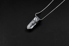 Water Clear Nepalese Inclusion Quartz pendant shown on black background with hand-hammered oxidized sterling silver setting.