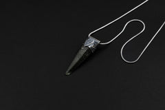 Nepal Chlorite Rutile Phantom Quartz Stack Pendant shown on black background with adjustable black cotton necklace and oxidized silver cap.