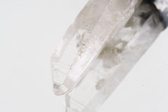 Close-up of raw skeletal Aquamarine showing linear crystal texture, icy green-blue tones, and sterling silver cap.