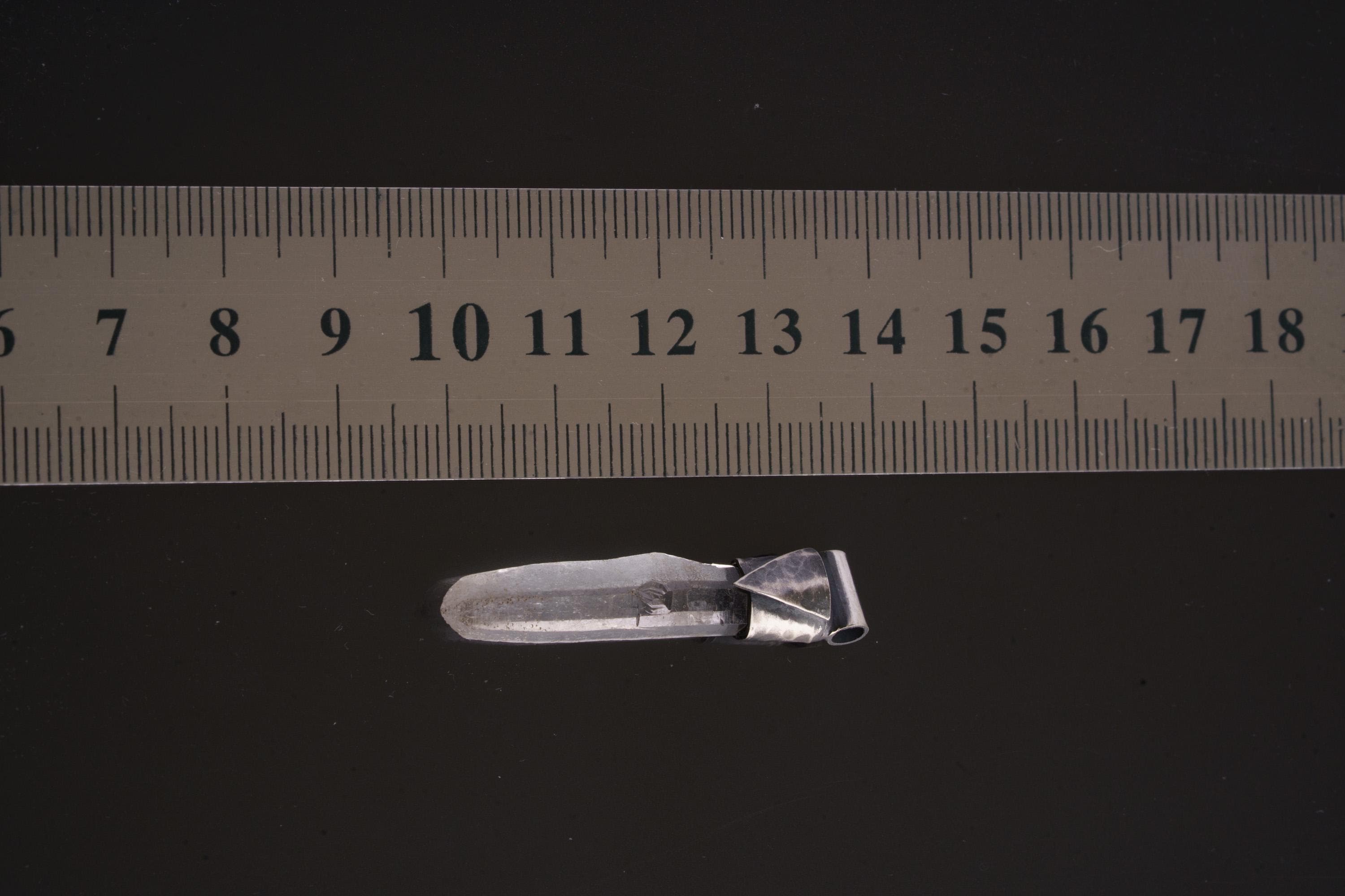 Water Clear Nepalese Inclusion Quartz pendant shown beside a ruler for scale with geometric oxidized silver cap.