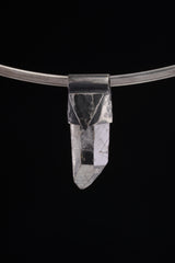 Water Clear Nepalese Inclusion Quartz Pendant shown on black background with black cotton necklace and raw clear Quartz point.