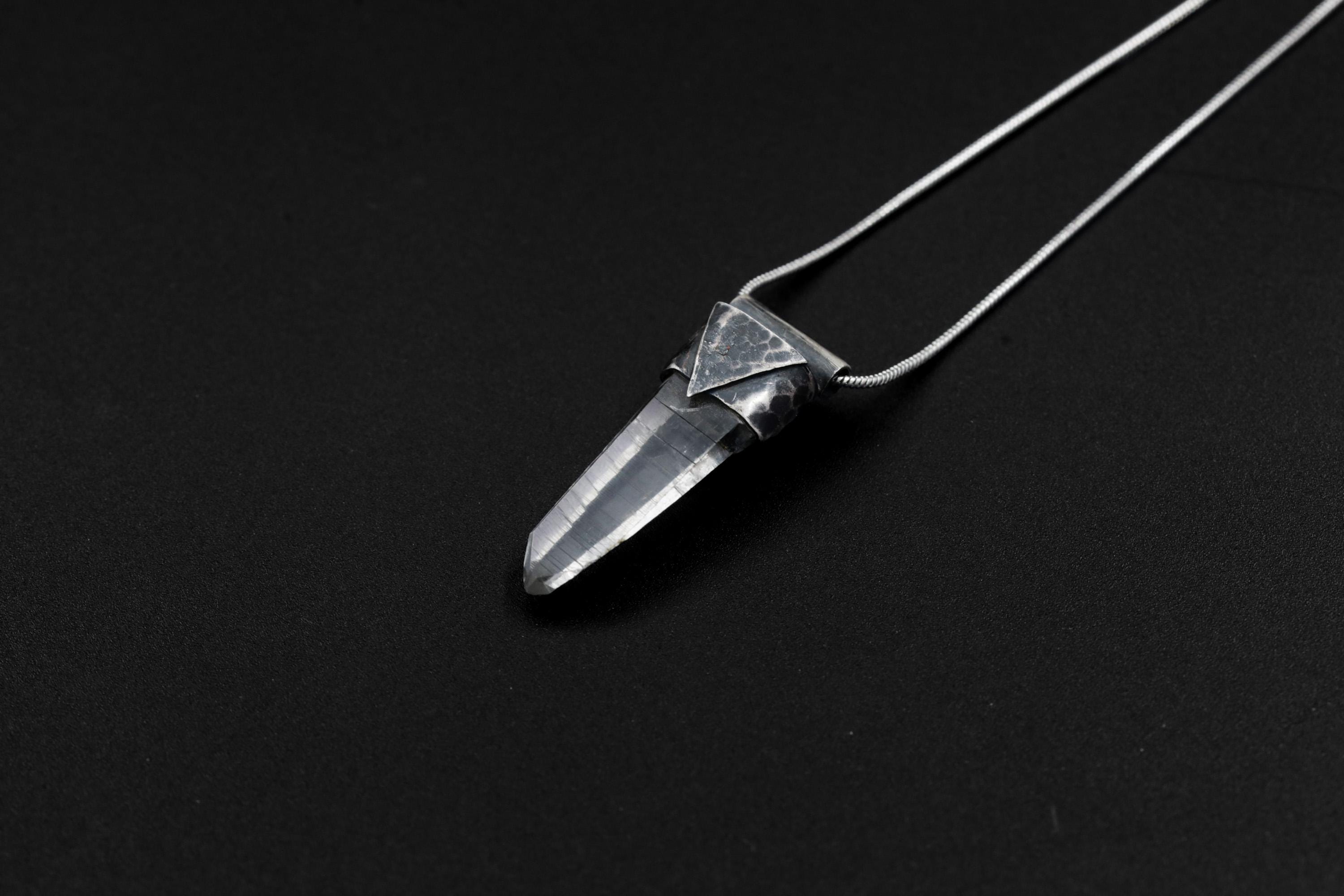 Water Clear Nepalese Inclusion Quartz Pendant shown on black background with black cotton necklace and raw clear Quartz point.