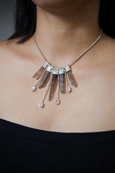 Blue Moonstone Smoky Citrine Phantom Quartz necklace shown worn on the chest with five cascading crystal drops and sterling silver chain.