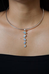 Australian Opal Doublet droplet pendant shown worn on a model, with textured sterling silver and flowing five-stone cascade.