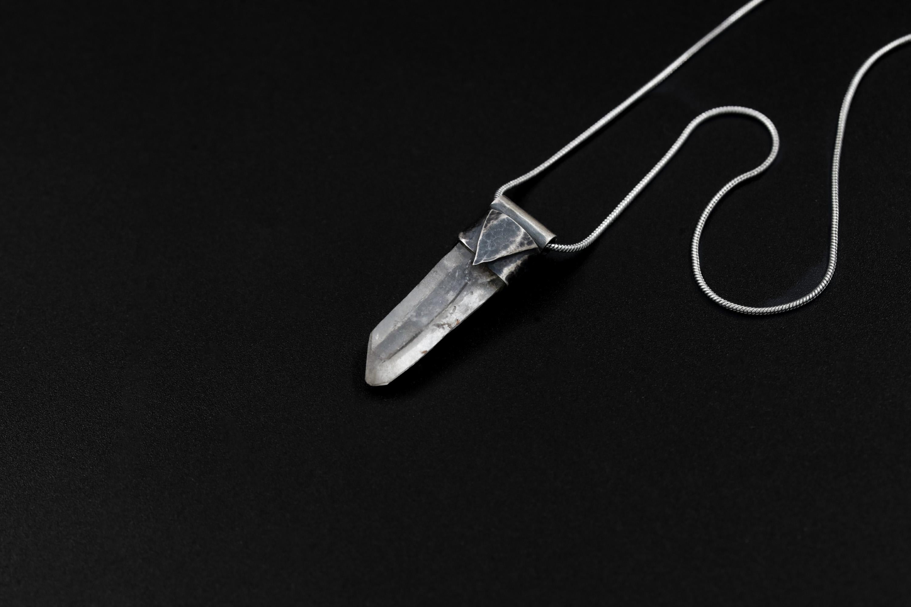 Water Clear Nepalese Inclusion Quartz Pendant shown on black background with oxidized sterling silver cap and black cotton necklace.