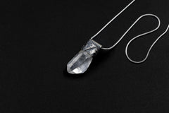Water Clear Nepalese Inclusion Quartz Pendant shown on black background with oxidized sterling silver cap and black cotton necklace.