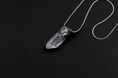 Water Clear Nepalese Inclusion Quartz Stack Pendant shown on black background with oxidized sterling silver cap and black cotton necklace.