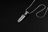 Water Clear Nepalese Inclusion Quartz pendant shown on black background with oxidized sterling silver cap and black cotton necklace.