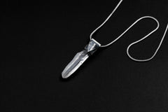 Water Clear Nepalese Inclusion Quartz pendant shown on black background with oxidized sterling silver cap and black cotton necklace.
