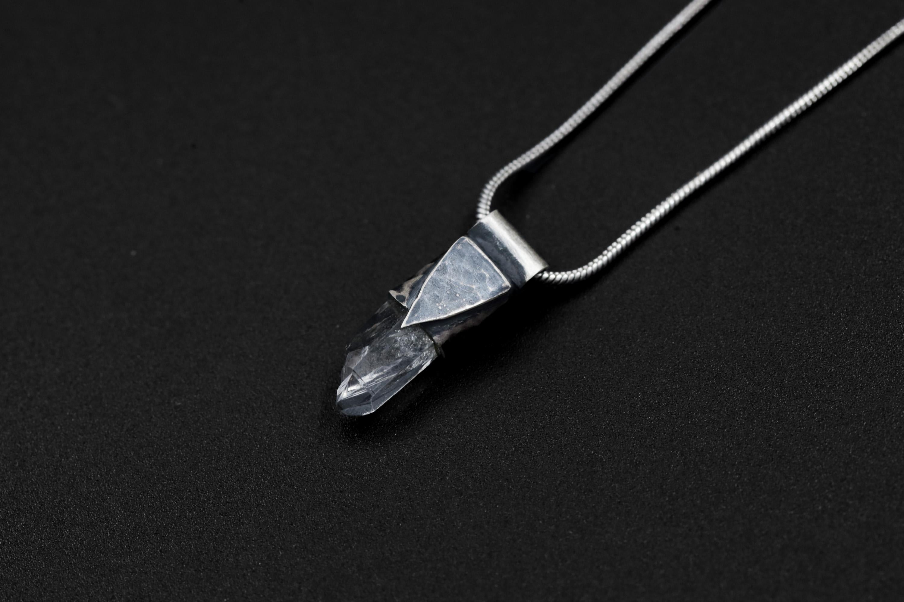 Water Clear Nepalese Inclusion Quartz pendant shown on black background with oxidized sterling silver cap and black cotton necklace.