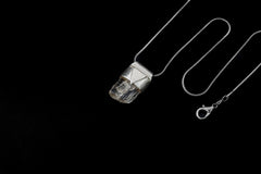 Clear Rainbow Inclusion Spodumene Stack Pendant shown on black background with adjustable black cotton necklace and silver cap.