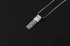 Small Terminated Aquamarine Stack Pendant shown on black background with adjustable black cotton necklace and silver cap.