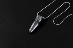 Water Clear Nepalese Inclusion Quartz Pendant shown on black background with oxidized sterling silver cap and black cotton necklace.