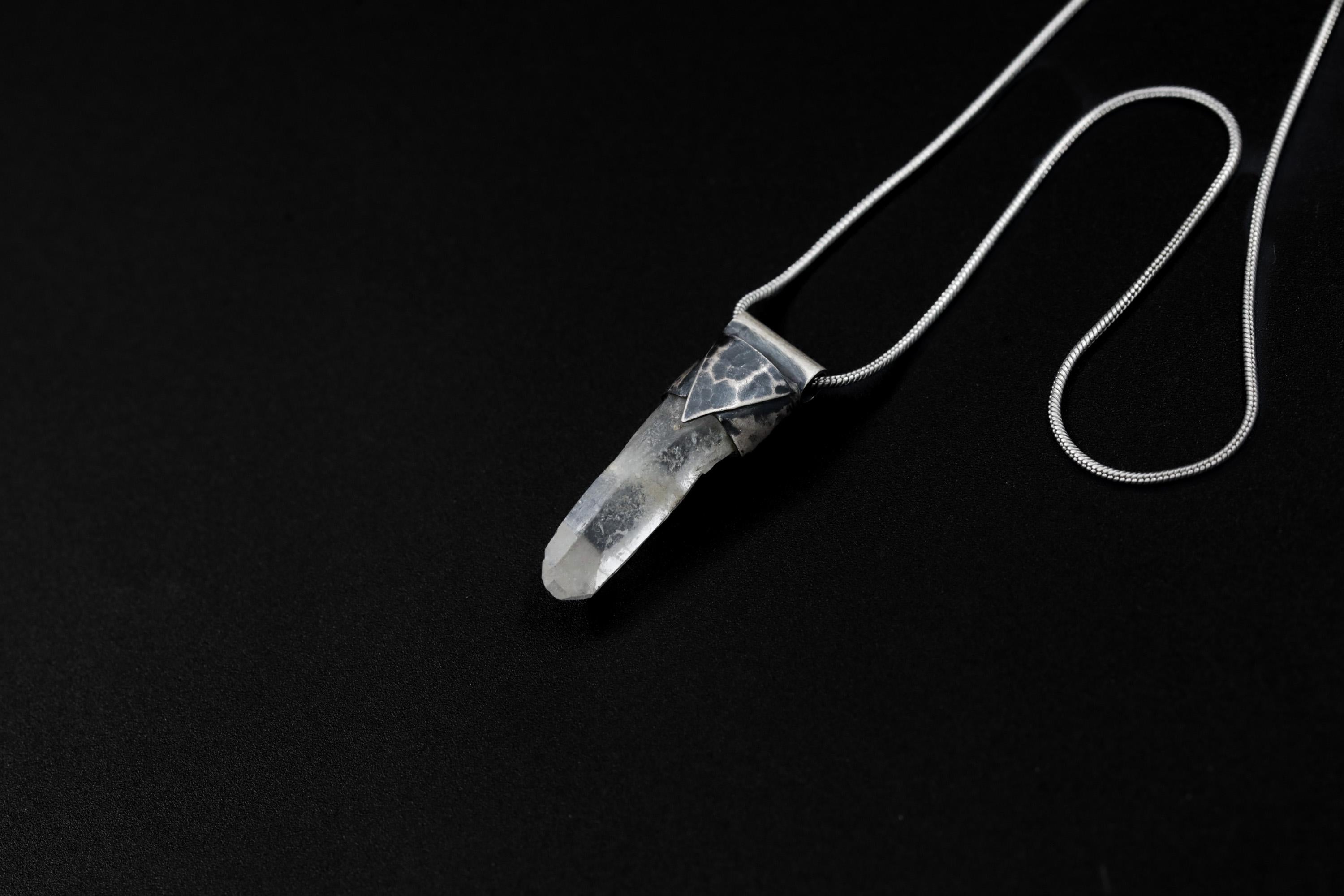 Water Clear Nepalese Inclusion Quartz pendant shown on black background with oxidized sterling silver cap and black cotton necklace.