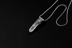 Water Clear Nepalese Inclusion Quartz pendant shown on black background with oxidized sterling silver cap and black cotton necklace.