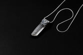 Water Clear Nepalese Inclusion Quartz pendant shown on black background with oxidized sterling silver cap and black cotton necklace.