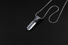 Water Clear Nepalese Inclusion Quartz pendant shown on black background with oxidized sterling silver cap and black cotton necklace.