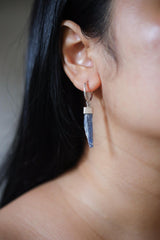 Blue Kyanite hoop earring shown worn on the ear, with 5 cm crystal drop and high-shine sterling silver.