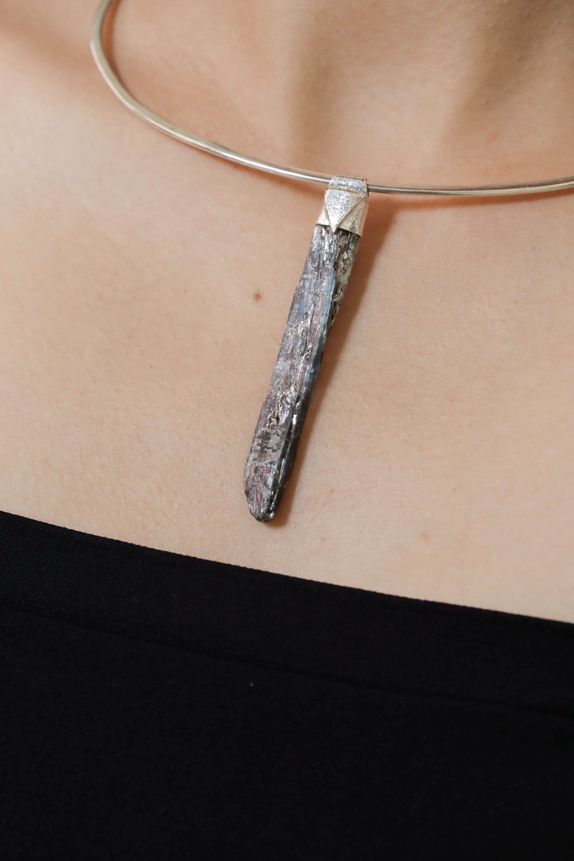 Australian Ocean Kyanite Stack Pendant shown worn on the chest with sterling silver cap and slim blue crystal.