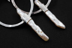 Close-up of Baroque Pearl portal earrings showing hammered silver texture and elongated natural Pearl dangles.