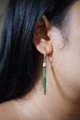 Green Jade hoop earring shown worn on the ear, with polished green stone and shiny sterling silver detail.