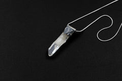 Skeletal Aquamarine Stack Pendant shown on black background with sterling silver cap and raw green-blue crystal body.