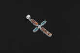 Celestial Harmony Cross pendant shown on a dark background with Red Kyanite, Apatite, Moonstone, and sterling silver setting.