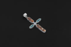 Celestial Harmony Cross pendant shown on a dark background with Red Kyanite, Apatite, Moonstone, and sterling silver setting.