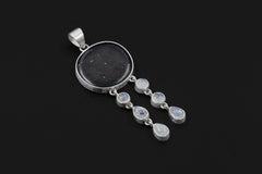 Shungite Moonstone pendant on a dark background, showing high-shine sterling silver, cotton cord, and lunar dangle design.