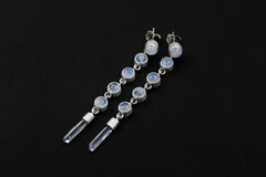 Handmade Blue Moonstone and Clear Quartz drop earrings displayed on dark background with sterling silver settings.