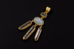 Aquamarine Blue Moonstone Clear Quartz pendant shown on a dark background with 18k gold-plated sterling silver setting.