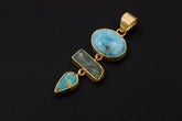 Larimar Aquamarine Arizona Turquoise pendant in 18k gold-plated 925 sterling silver shown on natural texture with chain.