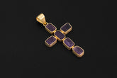 Raw Amethyst cross pendant in 18k gold-plated sterling silver shown on a dark background with deep violet stones.