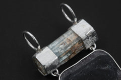 Close-up of raw Aquamarine cylinder and triangular Watermelon Tourmaline pendant with dual circular sterling silver bails.