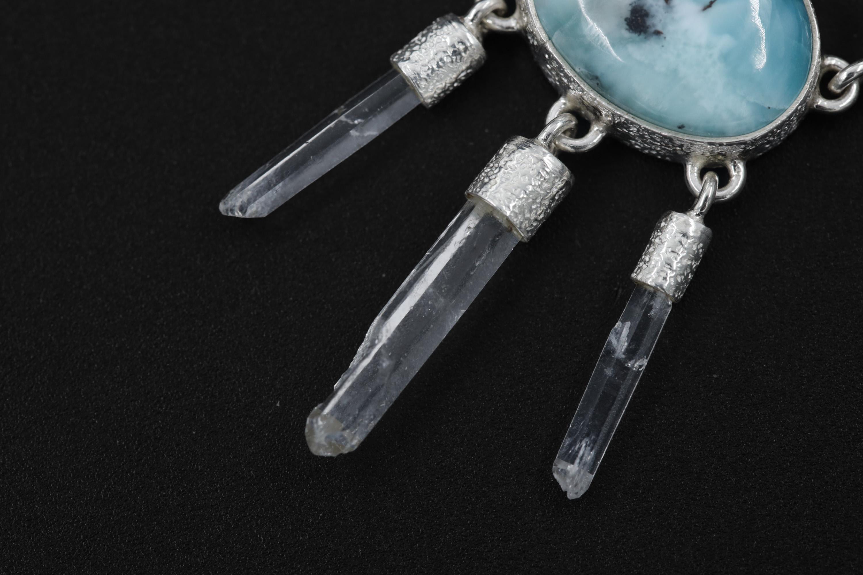 Close-up of three raw Clear Quartz points hanging beneath a Larimar Moonstone pendant in high-shine sterling silver.
