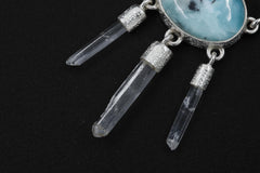 Close-up of three raw Clear Quartz points hanging beneath a Larimar Moonstone pendant in high-shine sterling silver.