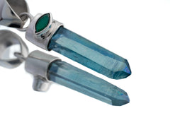 Close-up of Aqua Aura Quartz pendant showing twin blue crystal points and high-shine sterling silver setting.