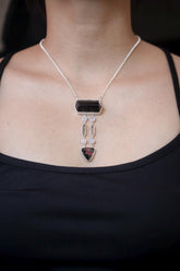 Celestial Pathways crystal necklace shown worn on the chest, with Dravite Tourmaline, Moonstone, Clear Quartz, and Rubellite in 925 silver.